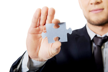 Businessman holding a puzzle.