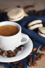 Gentle colorful macaroons and  coffee in mug