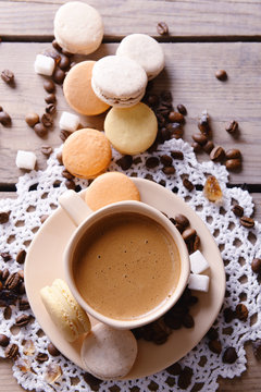 Gentle colorful macaroons and  coffee in mug