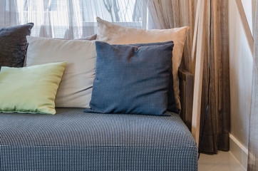 pillows on modern black sofa in living room