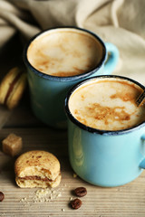Beautiful composition with tasty cappuccino on wooden table