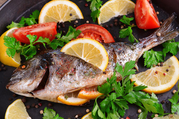 Tasty baked fish on table close-up