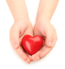 Fototapeta premium Heart in child hands isolated on white