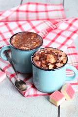 Mugs of hot coffee with marshmallow