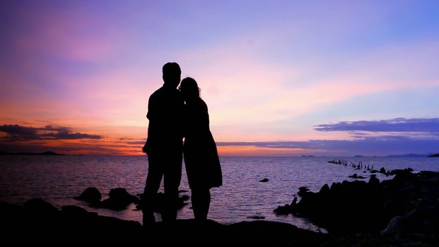 Silhouette couple in love taking self-portrait on the phone