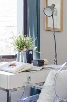 Vase Of Flower On White Desk With Lamp