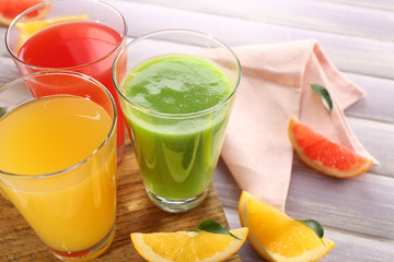 Fresh juices with fruits on wooden table
