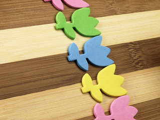 Colorful cut tulips on a chopping board.