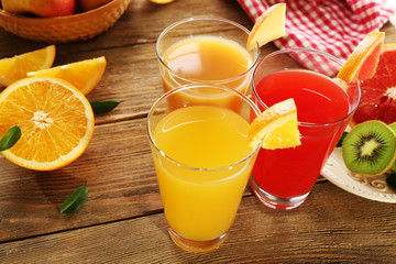 Fresh juices with fruits on wooden table