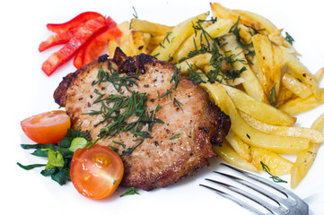 Grilled pork steak on white plate.
