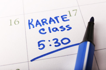 Written plan Karate Class on calendar page background