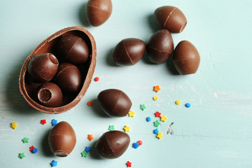 Chocolate Easter Eggs on color wooden background