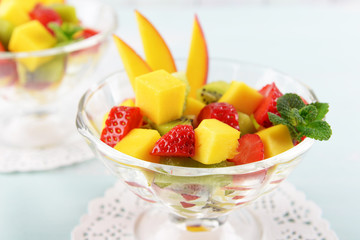 Fruit salad with mint in glassware