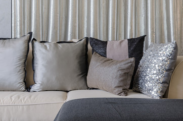 pillows on sofa with steel curtain as background