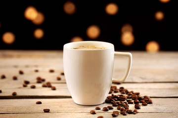 Cup of coffee on table on brown background