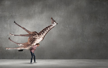Girl carrying giraffe