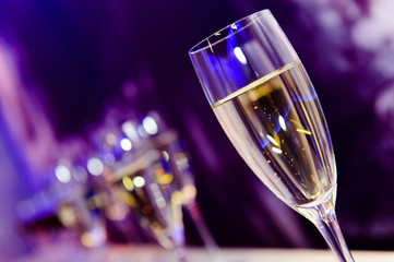 Champagne glass in nightclub neon lilac, blue, purple lights - 78534503
