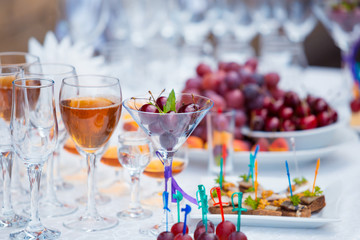 Banquet table with fruits, juice and snacks close up