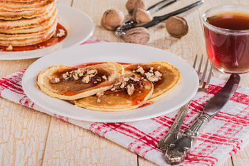 Homemade pancakes with walnuts and strawberry jam