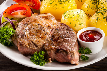 Grilled steak, boiled potatoes and vegetable salad