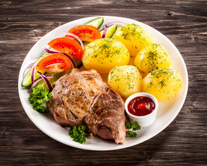 Grilled steak, boiled potatoes and vegetable salad