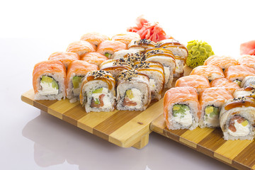 Salmon and eel sushi rolls on white background