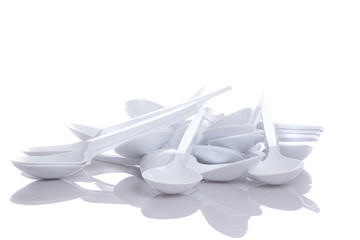 Fototapeta na wymiar white plastic spoons isolated on white background
