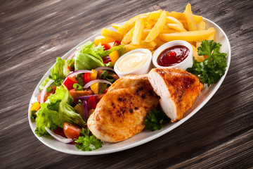 Fried chicken fillets, boiled potatoes and vegetable salad