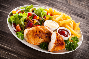 Fried chicken fillets, boiled potatoes and vegetable salad