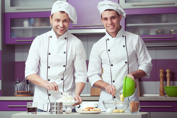 Tiramisu cooking concept. Portrait of two smiling men