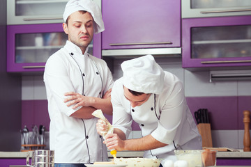 Tiramisu cooking concept. Portrait of two working men