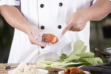 Chef present roasted pork with noodle ingredient