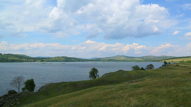Beautiful timelapse landscape with lake between hills - South ur