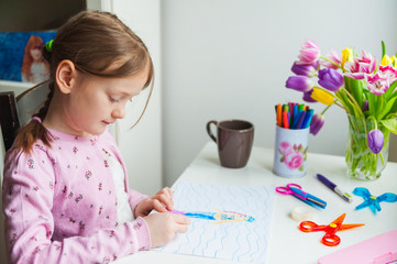 Little girl drawing at home