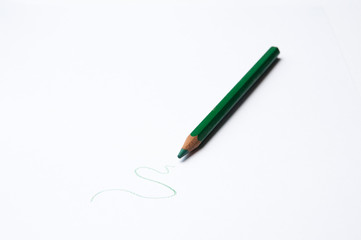 Green pencil on white background