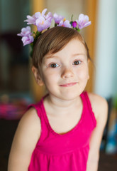 Interior portrait of a cute little girl playing at home