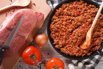 Bolognese sauce in skillet with ingredients horizontal top view