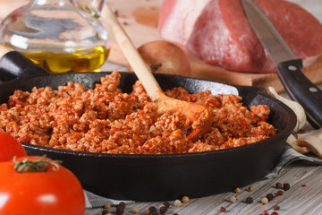 sauce Bolognese in a pan and ingredients closeup horizontal