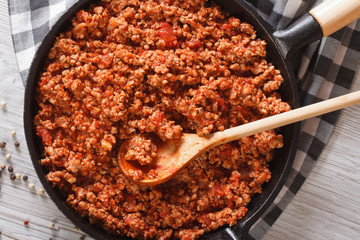 Bolognese sauce in a frying pan close-up horizontal top view