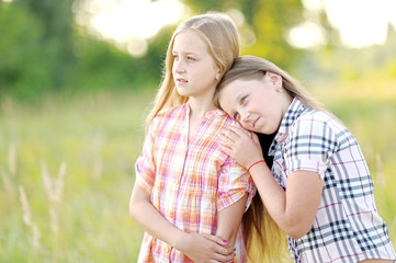 Fototapeta premium Portrait of two beautiful girlfriends on the nature