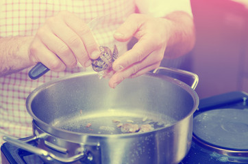 Chef is peeling clams, toned