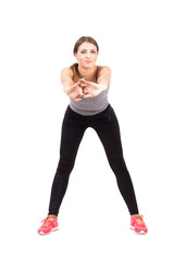 Young sporty woman stretching arms front