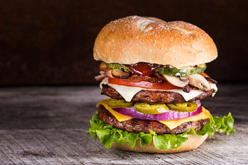 Double patty hamburger with a variety of ingredients - obrazy, fototapety, plakaty