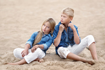 Portrait of a boy and girl on the beach in summer