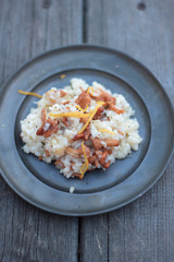 Risotto with chanterelle on a tin plate.