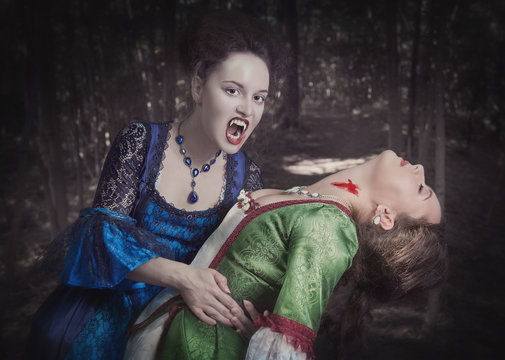 Beautiful vampire woman in medieval dress and her victim