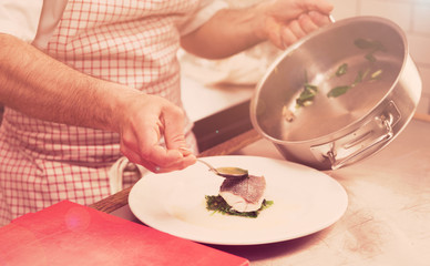 Obraz na płótnie Canvas Chef is serving steamed seabass, toned