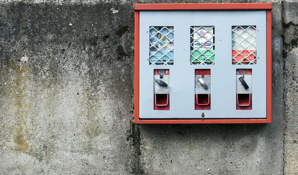 Candy and Gum Machine on Grunge Wall