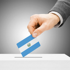 Voting concept - Male inserting flag into ballot box - El Salvad
