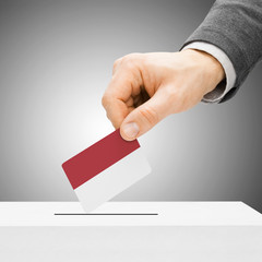 Voting concept - Male inserting flag into ballot box - Indonesia